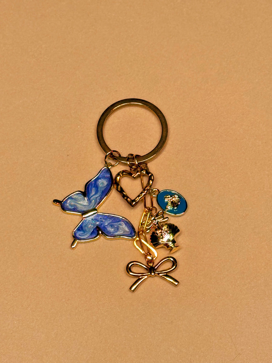 ANIMA — Gouden Sleutelhanger met Blauwe Vlinder